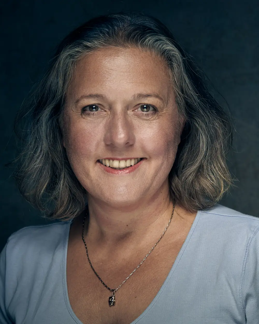 Modern actor headshot on a plain background