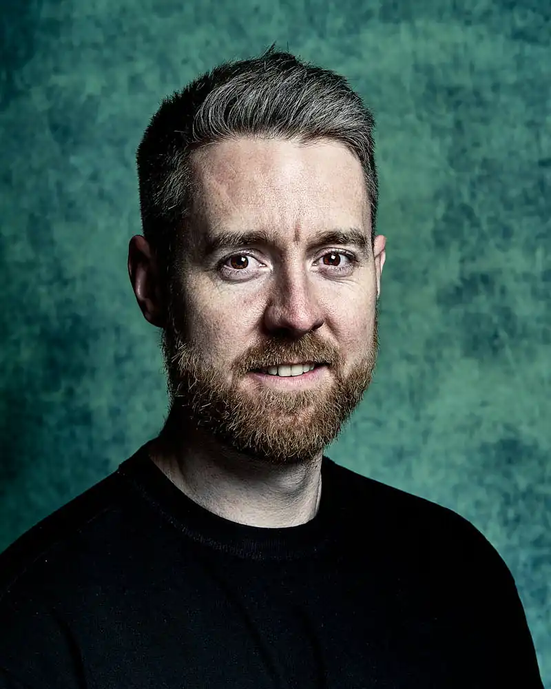 Actor headshot with a neutral studio backdrop