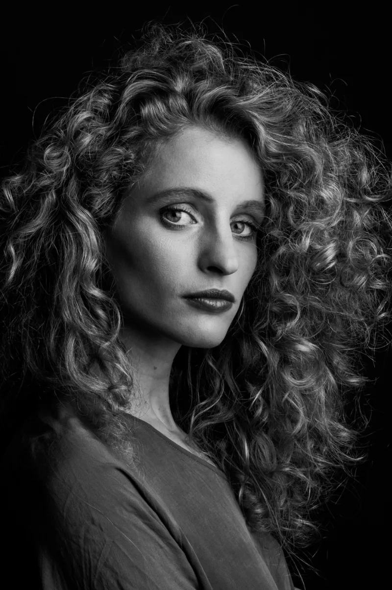 Actor headshot photographed against a plain studio background